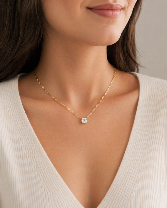 Model wearing Elmivra Lumière Solitaire round lab-grown diamond necklace in 18K yellow gold