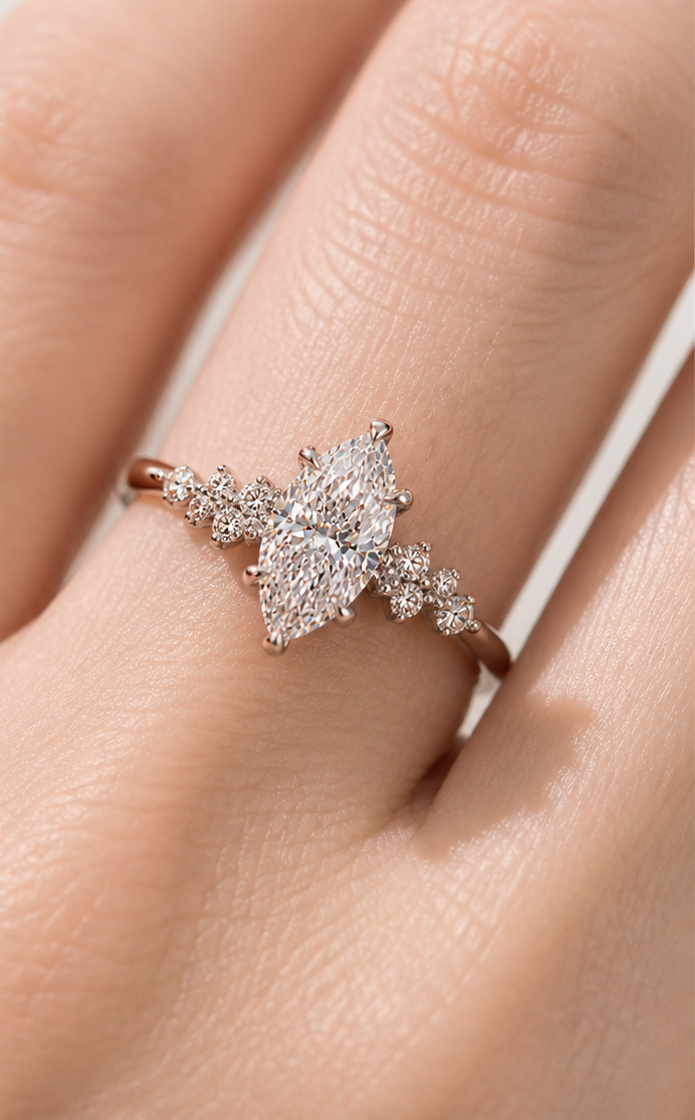 Close-up of marquise lab-grown diamond ring with crown-inspired side stones