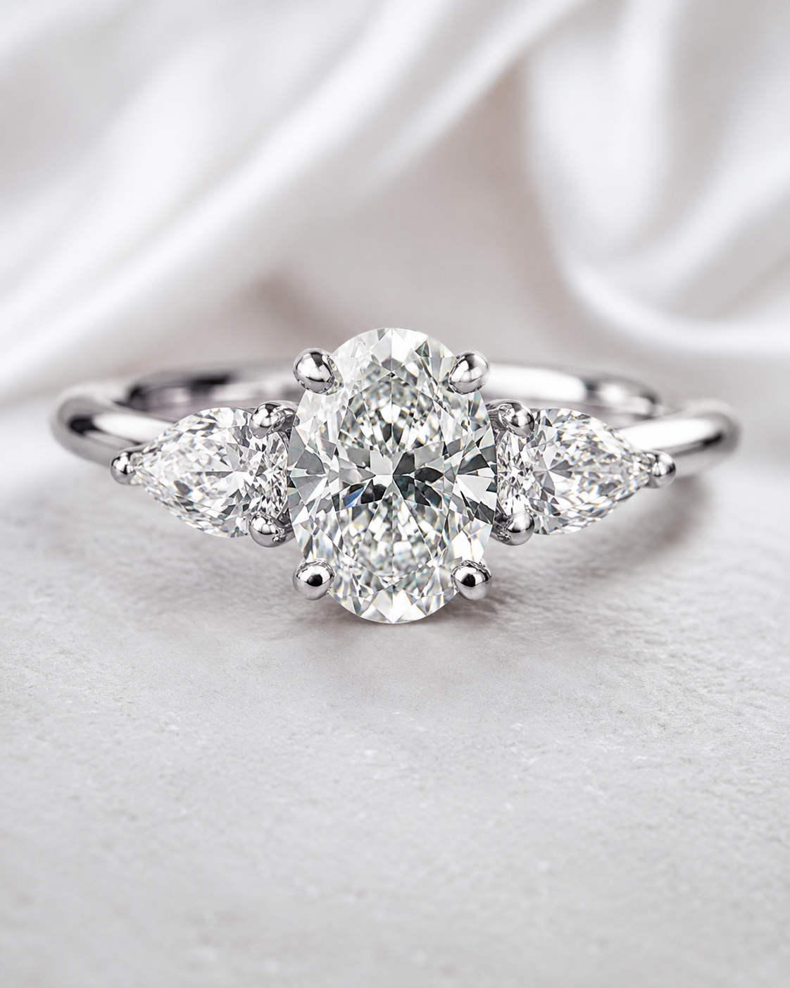 Celeste Three-Stone oval lab-grown diamond ring front view with pear side stones