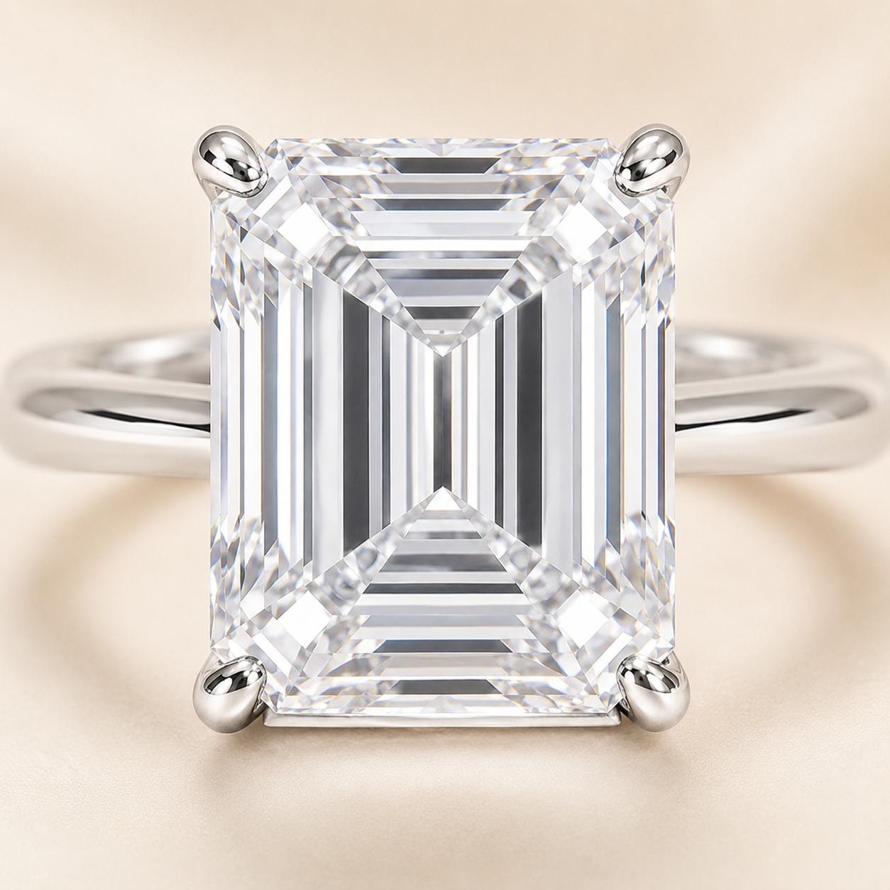 Close-up of emerald cut lab-grown diamond and four-prong white gold setting