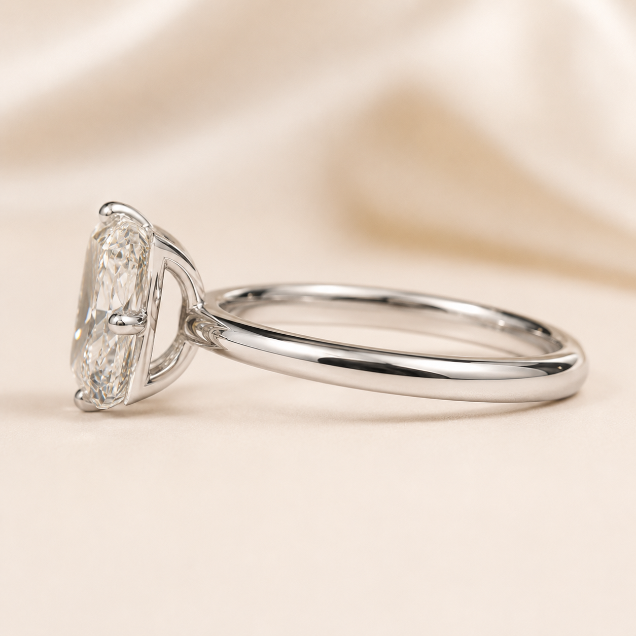 Side detail of Elmivra radiant cut solitaire ring in 18K white gold with plain band and no halo