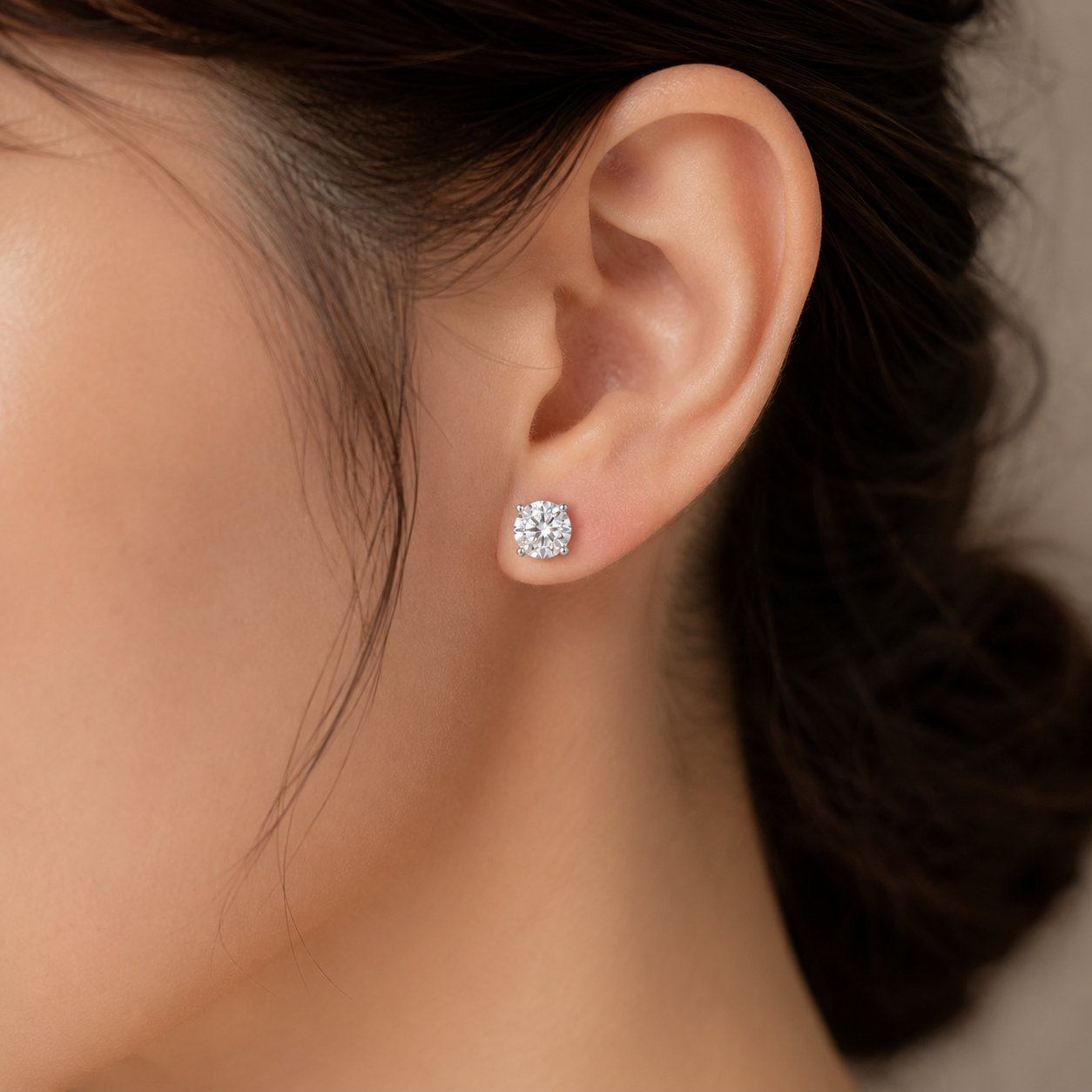 Elmivra 2 CTW round lab-grown diamond stud earrings in PT950 platinum worn on ear