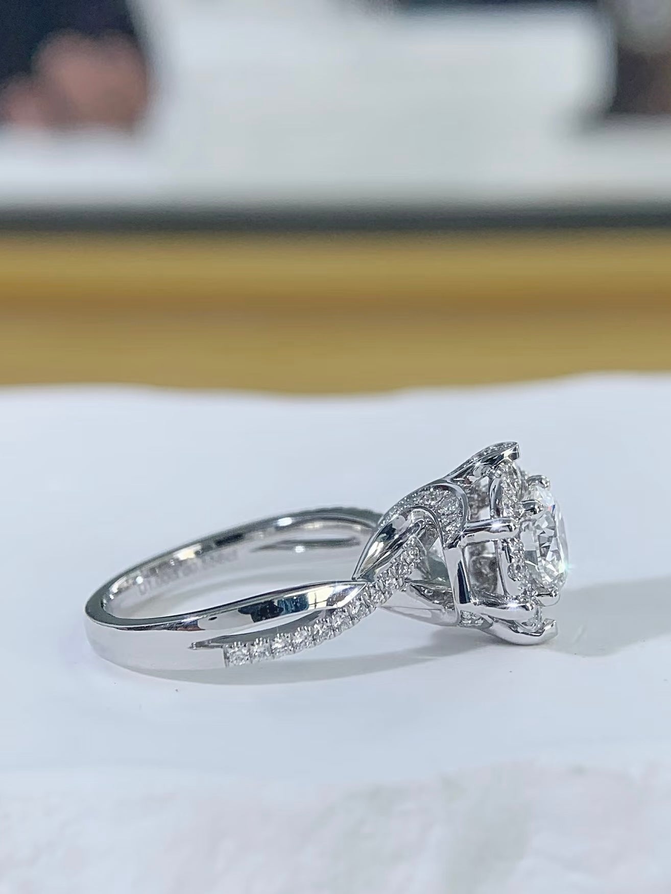 Angled view of Petal Halo diamond ring with pavé split shank
